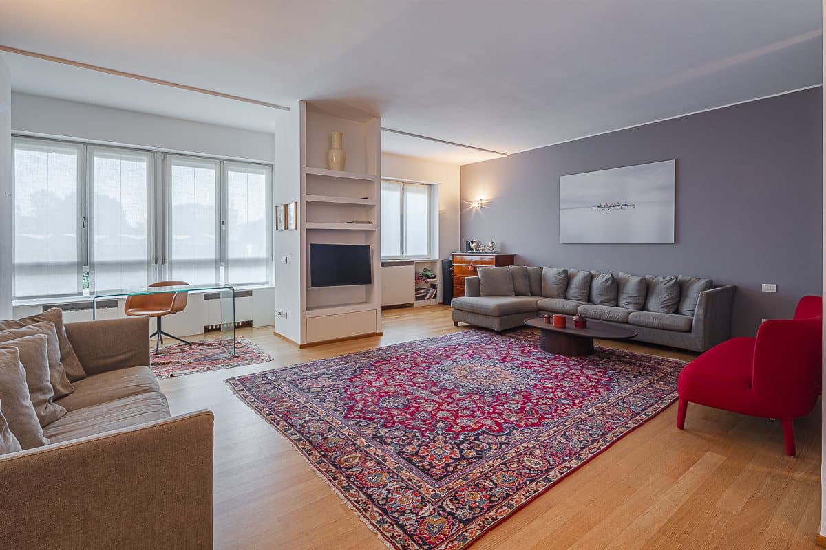 The bright living room with windows on three sides