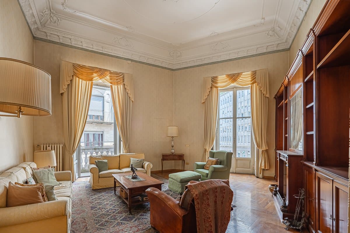 The period drawing room with decorated ceilings and tall windows