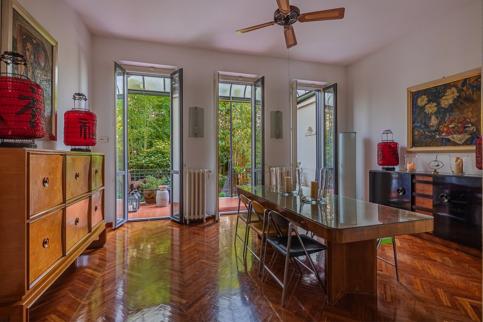 The townhouse's drawing room with parquet floors and windows onto the garden
