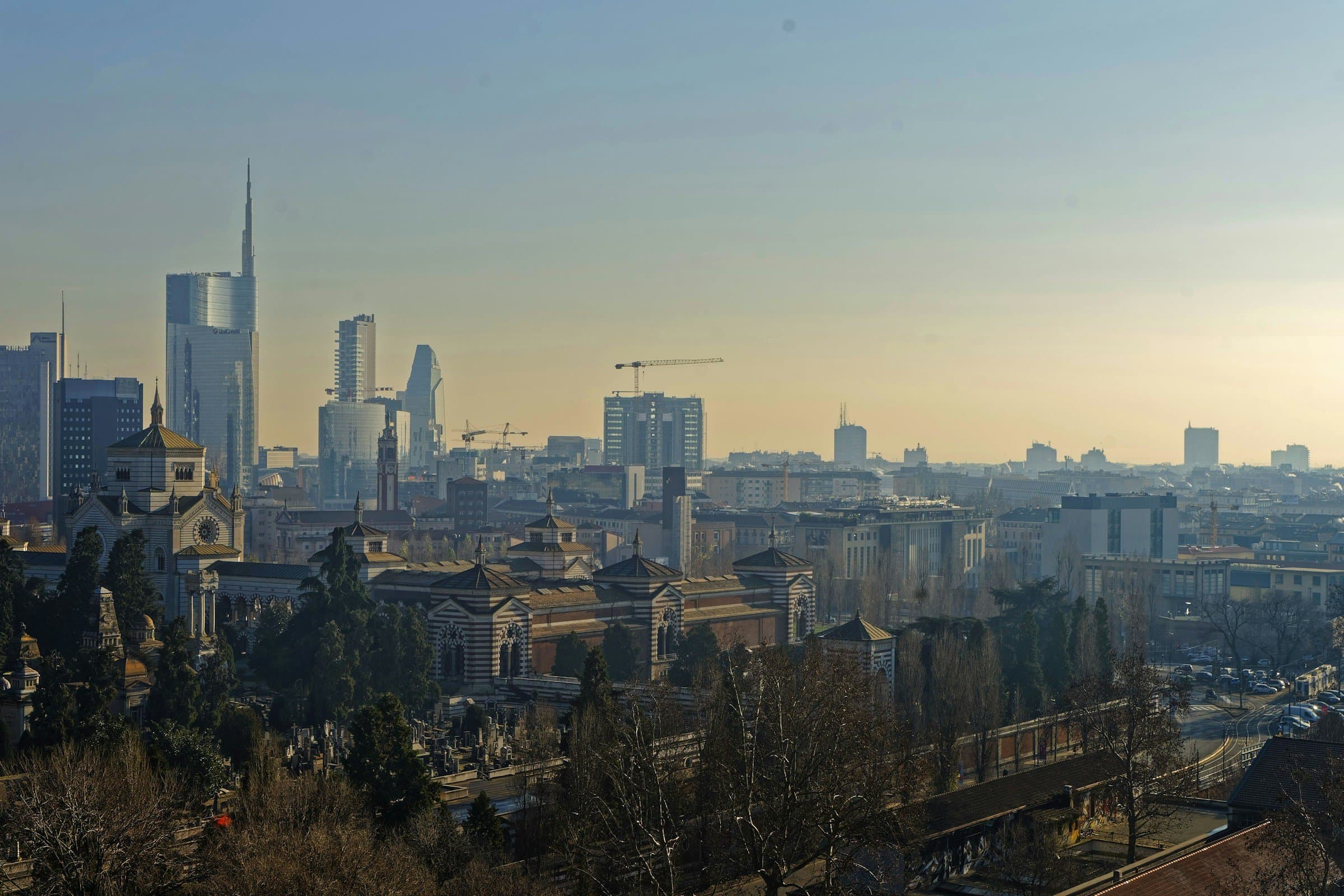 The Milan skyline on a winter morning, with haze over the rooftops